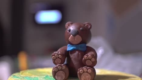 Tilt-down-footage-of-brown-bear-made-of-sugar-paste-fondant,-close-up-4K-isolated-shallow-depth-of-field-homemade
