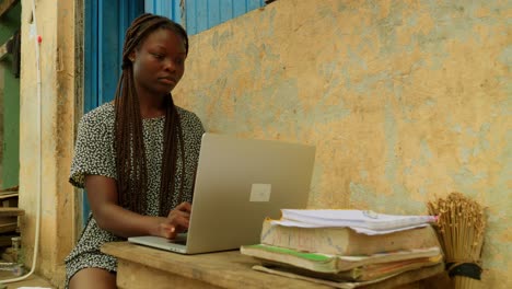 Using-internet-and-technology-to-learn-online,-a-young-woman-is-getting-access-to-education-from-her-remote-village-in-Kumasi,-Ghana-in-Africa
