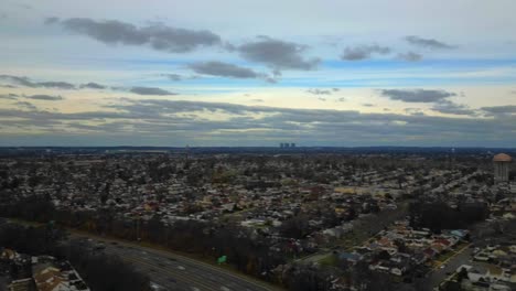 An-aerial-time-lapse-of-clouds-over-a-suburban-neighborhood-on-Long-Island,-New-York-on-a-cloudy-day
