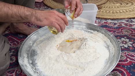 Wheat-flour-fermentation-process-to-make-dough-and-bake-flat-pizza-bread-in-old-brick-clay-oven-wood-fire-bonfire-burning-in-Iran-a-man-bake-bread-in-rural-countryside-village-life-local-people-Arabia