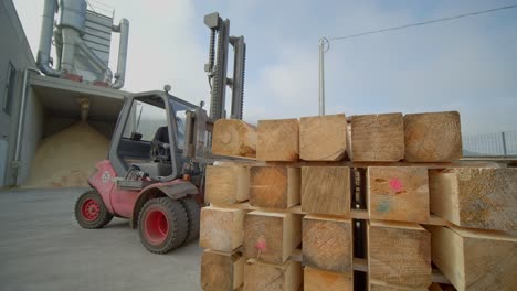 Forklift-Stocking-Tree-Trunks-In-Pile-One-Over-Each-Other