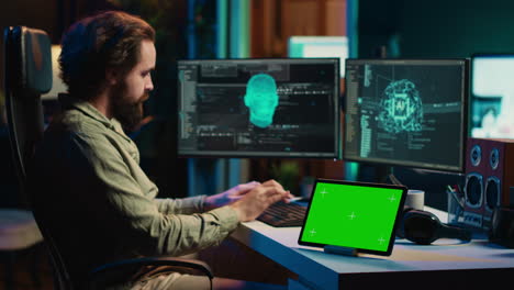 Developer-using-green-screen-tablet-updating-artificial-intelligence