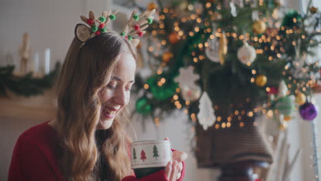 Mujer-Feliz-Oliendo-Café-Aromático-Durante-La-Navidad-En-Casa