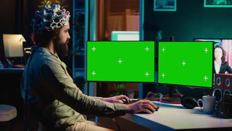 Computer-engineer-starting-mind-upload-process-using-green-screen-PC