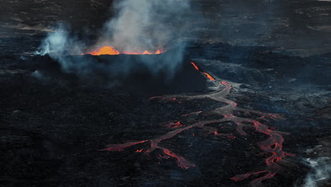 Flowing-lava,-hot-magma-spilling-out-of-the-volcano-crater,-aerial-side-view