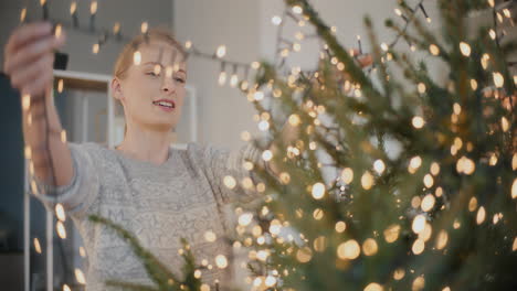 Woman-decorating-Christmas-tree-at-home