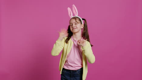 Adorable-cute-child-putting-bunny-ears-and-waving-at-camera,