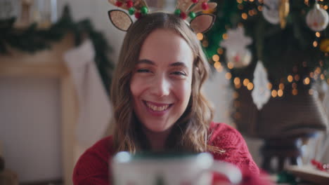 Portrait-of-happy-woman-offering-fresh-coffee-during-Christmas