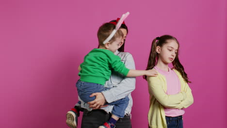Little-children-having-a-fight-against-pink-background