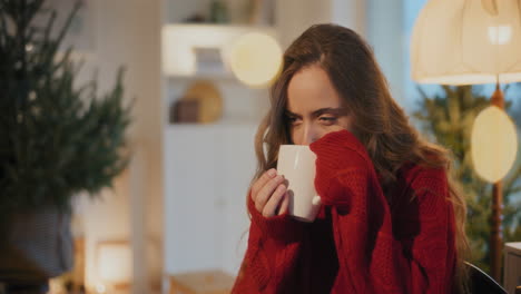 Woman-smelling-coffee-while-sitting-at-home