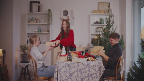 Woman-giving-Christmas-presents-to-friends