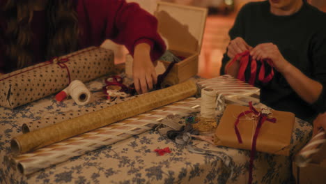 Female-friends-wrapping-gift-boxes-at-table