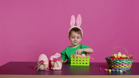 Sweet-young-boy-making-colorful-arrangements-for-Easter-holiday-festivity