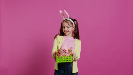 Smiling-pleased-girl-presenting-her-handcrafted-easter-basket