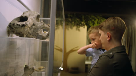 Woman-and-her-little-son-during-a-natural-history-museum-visit,-side-view
