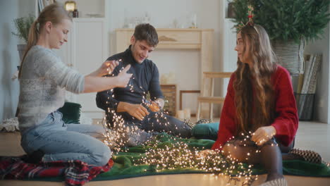 Man-and-women-sorting-tangled-glowing-lights