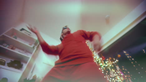 Excited-man-gesturing-while-dancing-during-Christmas-party-at-home