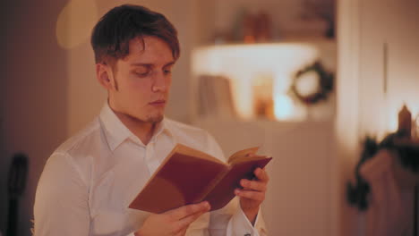 Man-reading-novel-at-home-during-Christmas