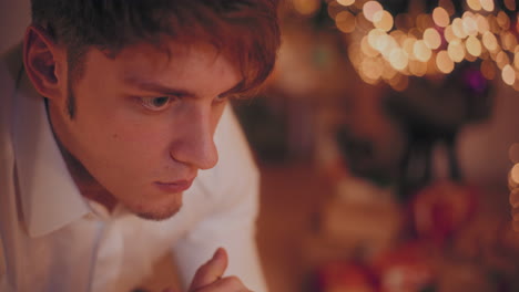 Closeup-of-pensive-man-during-Christmas-at-home