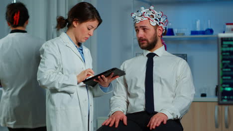 Man-with-brainwave-scanning-headset-visiting-professional-doctor