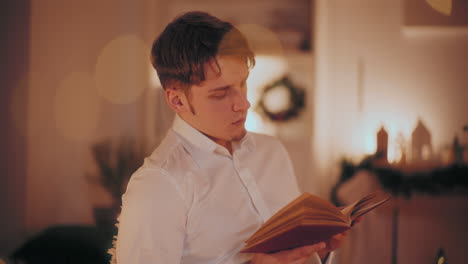 Hombre-Leyendo-Un-Libro-En-Casa-Durante-La-Navidad