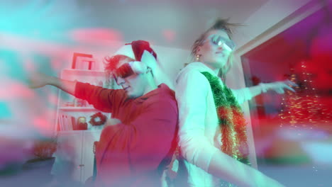 Excited-couple-dancing-back-to-back-at-home-during-Christmas
