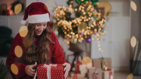 Cheerful-woman-in-Santa-hat-catching-Christmas-presents-at-home