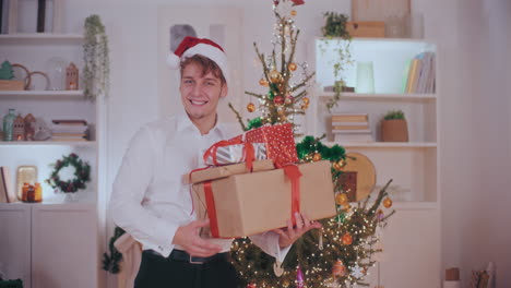 Handsome-man-carrying-various-Christmas-presents-at-home
