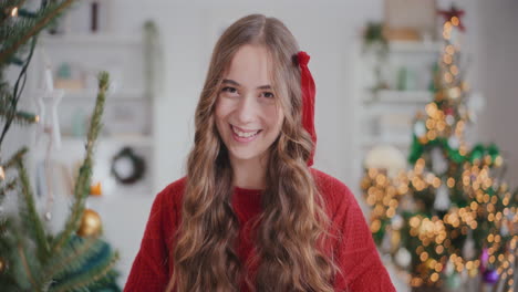 Cheerful-pretty-woman-at-home-during-Christmas