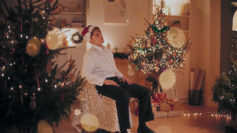 Worried-man-sitting-on-chair-at-illuminated-home-during-Christmas