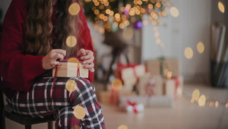 Frau-Bindet-Zu-Weihnachten-Zu-Hause-Ein-Band-An-Eine-Geschenkbox-Aus-Holz