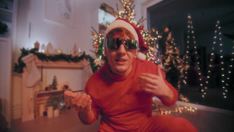 Excited-man-performing-during-party-at-illuminated-home-during-Christmas
