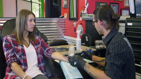 Woman-Sits-In-Chair-Having-Tattoo-In-Parlor-Shot-On-R3D