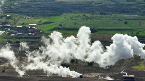 Smoke-spreading-in-the-environment-from-the-geothermal-power-plant,-aerial-shot