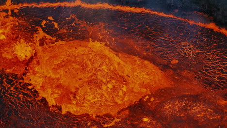Unique-view-of-red-hot-lava-exploding,-boiling,-and-bubbling,-drone-close-up