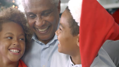 Close-Up-Of-Children-With-Grandfather-And-At-Christmas