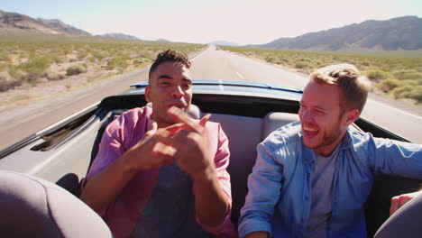 Two-Male-Friends-On-Road-Trip-In-Convertible-Car-Shot-On-R3D