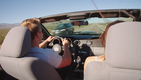 Couple-On-Road-Trip-Driving-In-Convertible-Car-Shot-On-R3D