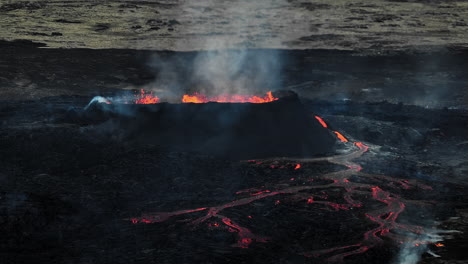 Flowing-lava,-hot-magma-spilling-out-of-the-volcano-crater,-aerial-side-view