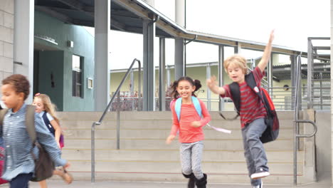 Junge-Schulkinder-Springen-Beim-Verlassen-Der-Schule-Die-Stufen-Hinunter