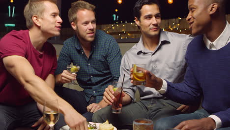 Male-Friends-Enjoying-Night-Out-At-Cocktail-Bar-Shot-On-R3D