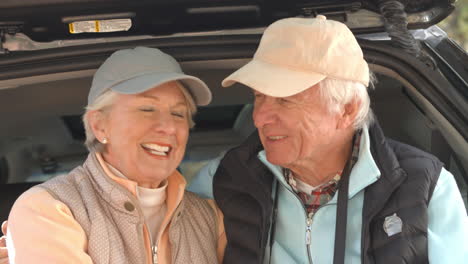 Senior-couple-at-back-of-car-before-hiking,-close-up-shot