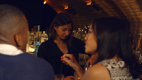 Couple-Enjoying-Night-Out-At-Cocktail-Bar,-Slow-Motion