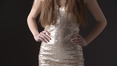 Tilt-shot-of-glamorous-young-woman-in-sparkly-evening-dress