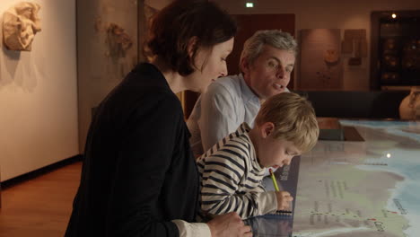 Family-On-Trip-To-Museum-Looking-At-Map-Shot-On-R3D