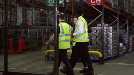 Staff-walking-though-warehouse-with-manager,-shot-on-R3D