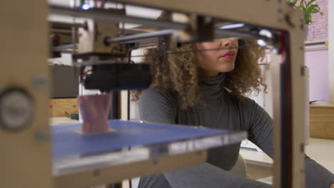 Female-designer-working-with-3D-printer-in-a-design-studio,-shot-on-R3D