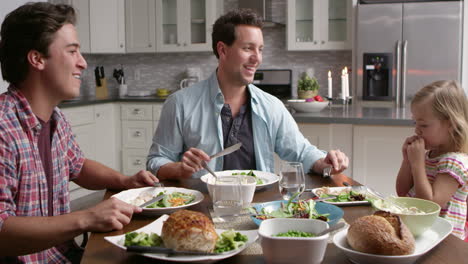 Male-gay-couple-and-daughter-dining-in-their-kitchen,-shot-on-R3D