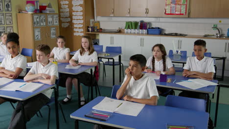 Pupils-In-Class-With-Teacher-Answering-Question-Shot-On-R3D