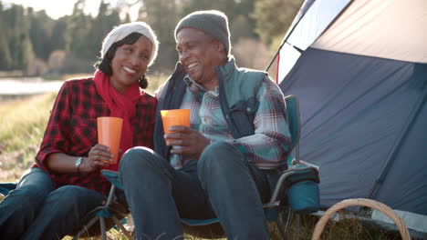 Senior-black-couple-on-camping-trip-outside-tent,-close-up